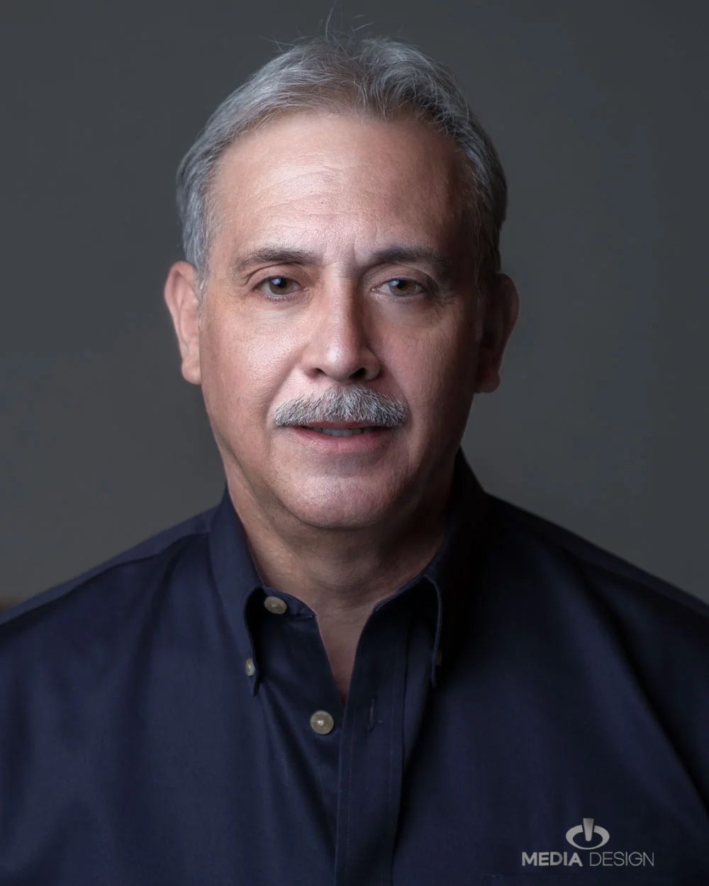 Mark Camacho, Media Design Inc, Headshot, Man in Navy Shirt